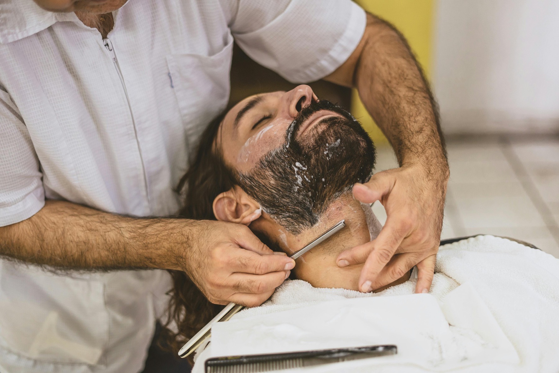 Barber applying after-shave